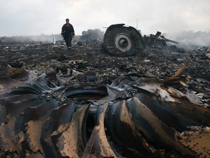 An Emergencies Ministry member walks at a site of Malaysian airliner flight MH17, which was brought down over eastern Ukraine, killing all 295 people aboard.