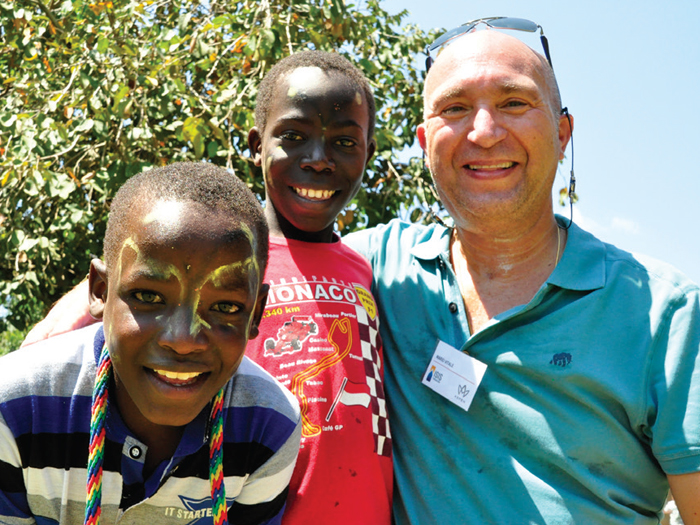Aspen Insurance CEO Mario Vitale with some friends in the  village of Kiwoko, in Central Uganda.