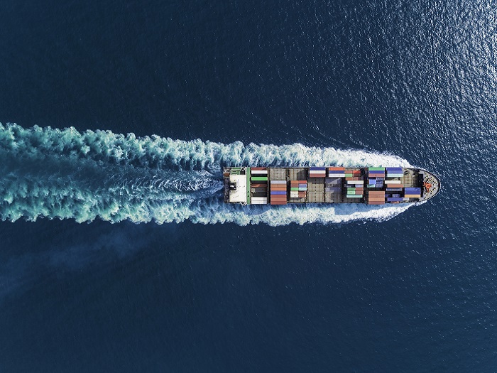 Aerial top view container ship full speed