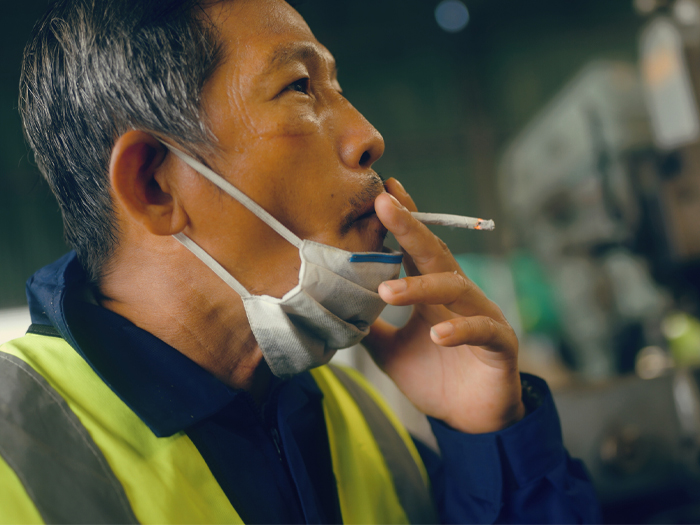 A worker smokes marijuana at his worksite