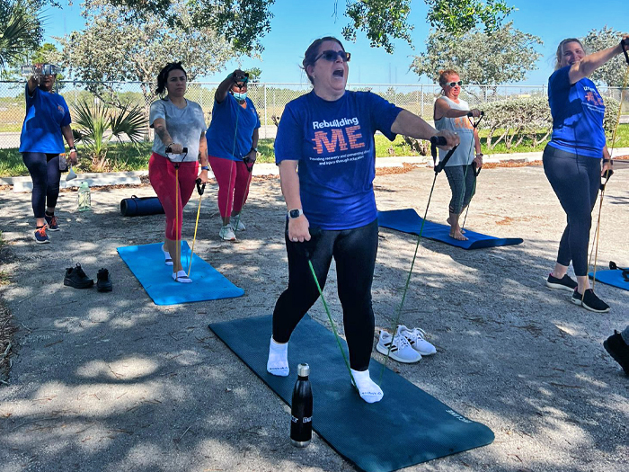 Miami-Dade County Public Schools employees participate in an outdoor fitness class