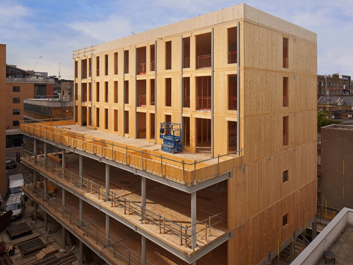 A mass timber framed building nears completion
