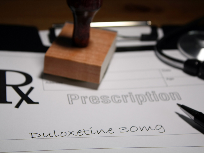 Close up of a prescription pad showing an order for duloxetine