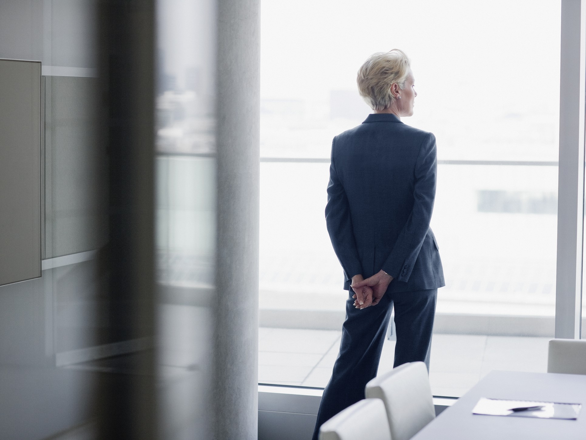 Businesswoman standing at window in office