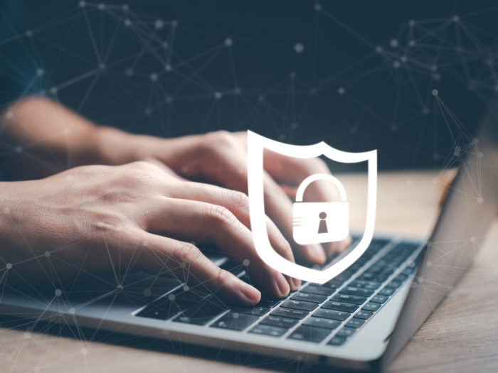 Man using network internet on laptop computer with lock protect virus icon.