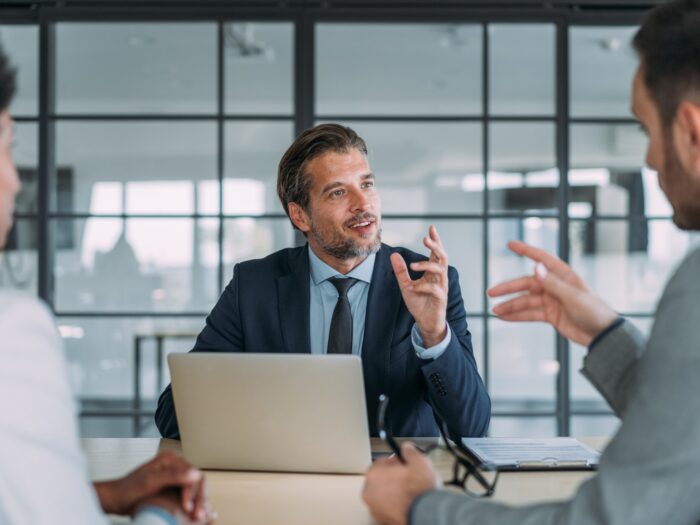 Shot of group of business persons in business meeting.
