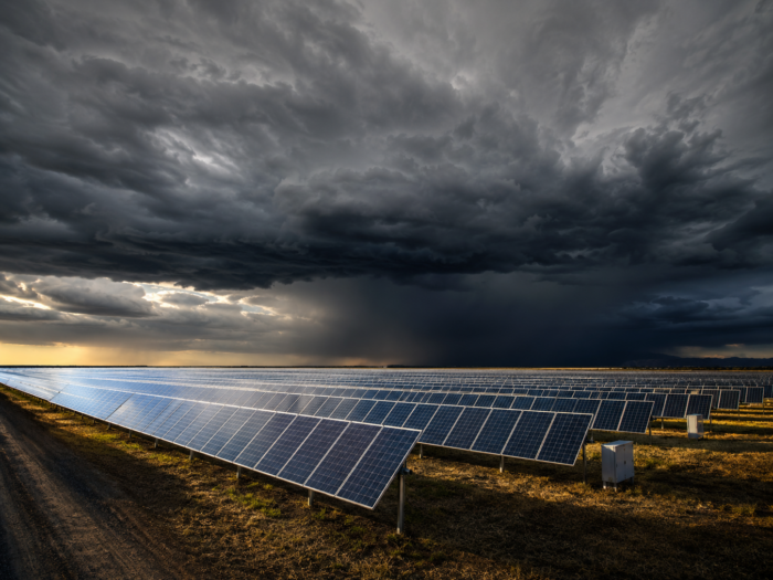 solar field under stormy skies concept